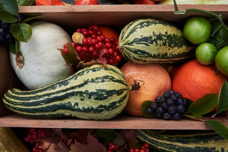 Delicious autumn vegetables in and around a wooden box. Full frame ripe vegetables. The concept of healthy eating.の写真素材