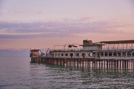 A pier stretching far into the sea against the backdrop of a beautiful sunset.の写真素材