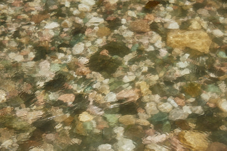 abstract blurred background. A fragment of a mountain river. Colorful stones under the water.の写真素材