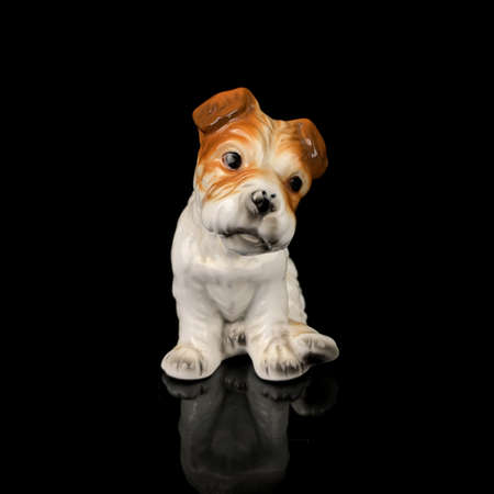 ceramic antique dog figurine. figurine of sabaki cocker spaniel on black backgroundの写真素材