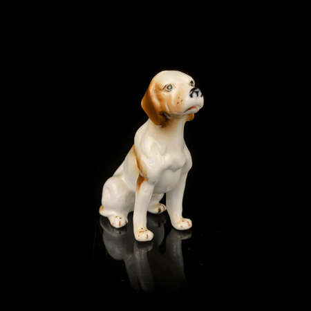 ceramic antique dog figurine. figurine of sabaki cocker spaniel on black backgroundの写真素材