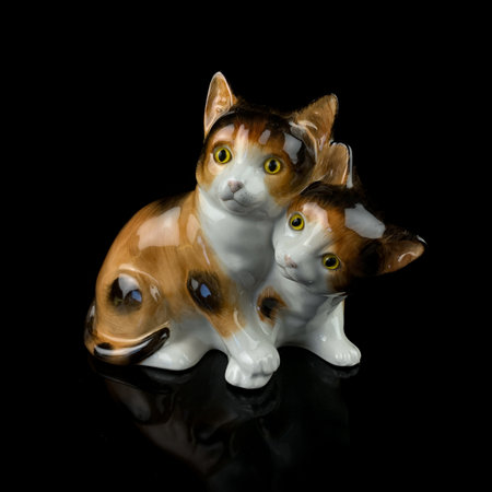 antique porcelain figurine of a ginger cat. vintage cat figurine on black isolated backgroundの写真素材