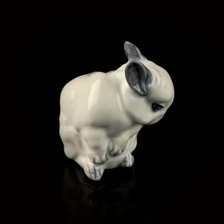 antique figurine of an easter bunny on a black isolated backgroundの写真素材