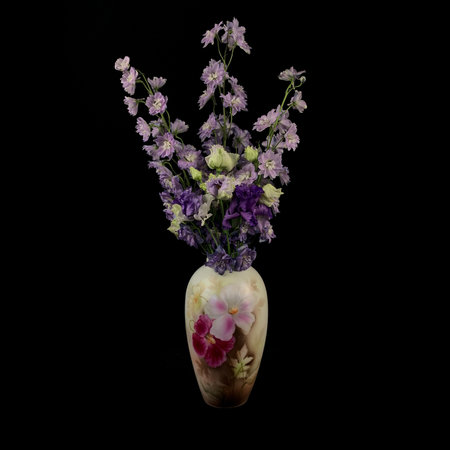 antique planter with a flowerpot on a black isolated backgroundの写真素材