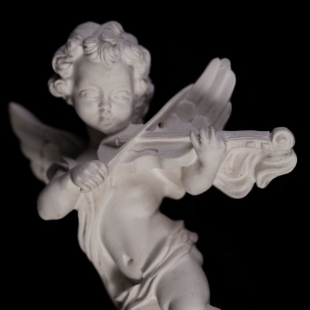Angelic figurine isolated on black background. close-up.の写真素材