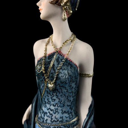 Female mannequin in blue dress, isolated on black background. porcelain antique figurine of a woman in retro clothes.の写真素材