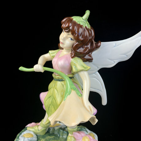 Angel figurine isolated on black background. close-up image. antique figurine of a little fairyのeditorial素材