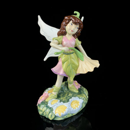 Angel figurine on a black background with reflection. Clipping path included. antique figurine of a little fairyのeditorial素材