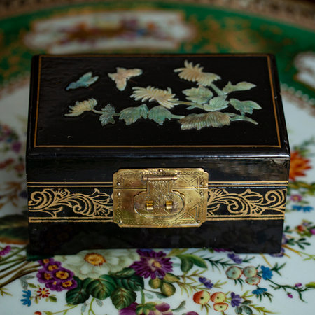 Antique black box with floral ornament on a turkish tray. gold antique boxの写真素材