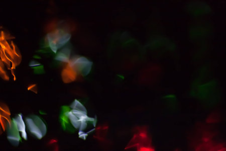 Abstract blurred colorful light on black backgrpound. Multicolor vivid reflections on the water. Cosmic, space and biological.の写真素材