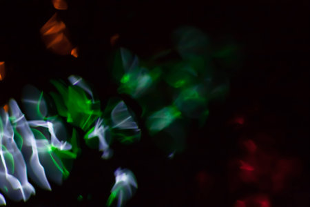 Abstract blurred colorful light on black backgrpound. Multicolor vivid reflections on the water. Cosmic, space and biological.の写真素材