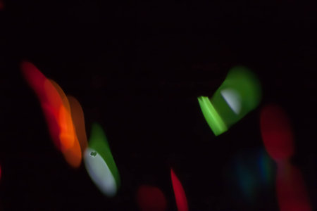 Abstract blurred colorful light on black backgrpound. Multicolor vivid reflections on the water. Cosmic, space and biological.の写真素材