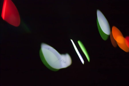 Abstract blurred colorful light on black backgrpound. Multicolor vivid reflections on the water....