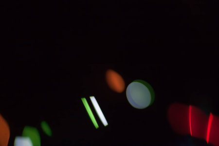 Abstract blurred colorful light on black backgrpound. Multicolor vivid reflections on the water. Cosmic, space and biological.の写真素材