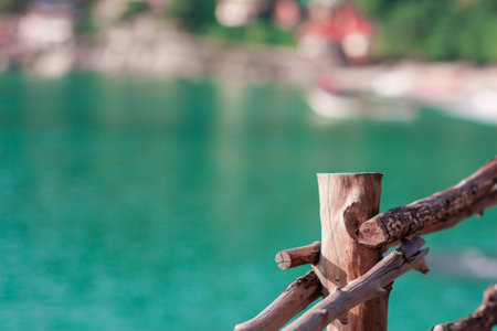 Light wooden fence with the blurred sea backdrop background with copy spaceの写真素材