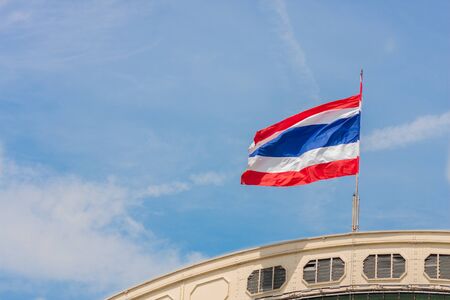 Waving Thailand flag and blue skyの写真素材