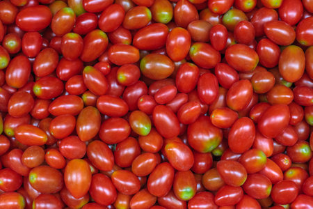Pile of many fresh red cherry tomatoes. Delicious raw healthy food background. Vegetable market in Bangkok, Thailandの写真素材