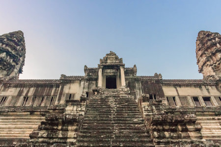 Angkor Wat Temple at sunrise on the blue sky. Beautiful front view. Stairs leading to upper gallery and tower of main Temple. Ancient temple complex Angkor Wat in Siem Reap, Cambodia.の写真素材