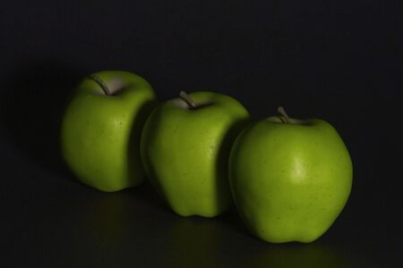 Line of Green Apples fade into black Backgroundの写真素材