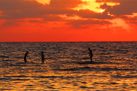 A shoot of surfers at sunsetの写真素材