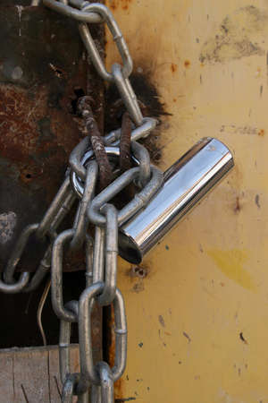 A lock and a chain on an old door.