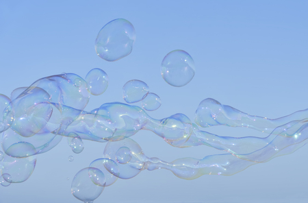 Rainbow big bubbles on the background of summer blue sky. Abstract soap bubble background, element for designers. Horizontalの写真素材