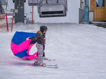 Zams, Austria - 22 Februar 2015: Children in ski school. Ski resort Landeck. Girls ride down from montain on ski. Colorful butterflies on the snowのeditorial素材