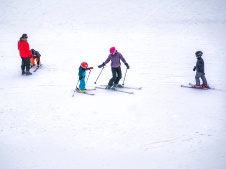 Zams, Austria - 22 Februar 2015: Ski resort Landeck. Children and adults ski on slope in Alps. Active sports vacationのeditorial素材