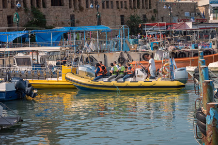Acre, Israel - 11.05.2018: Active outdoor rest on the Mediterranean sea. Sea trip of group of Arab young people on the inflatable rubber boat with a motorのeditorial素材