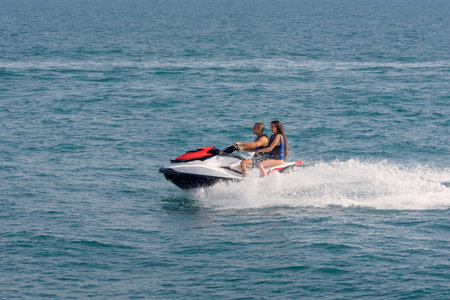Acre, Israel - 11.05.2018: Sports active rest on the Mediterranean sea. Young people racing on jet ski, water scooter. Active summer vacationのeditorial素材