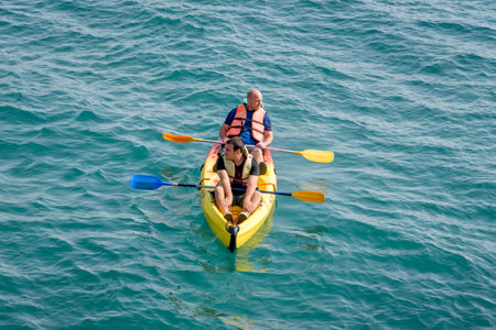 Acre, Israel - 11.05.2018: Sports outdoor active rest. Two young men paddling on tandem sea kayak. Active summer vacation on the Mediterranean seaのeditorial素材