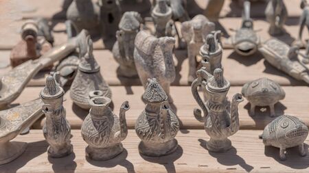 Bronze jugs, figures. Goods, souvenirs for tourists in Petra, Jordan. Close up Background