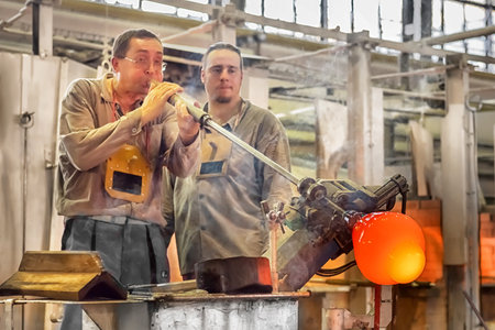 Transforming a hot mass of glass drawn from a hot oven into a work of art. The glass making process...