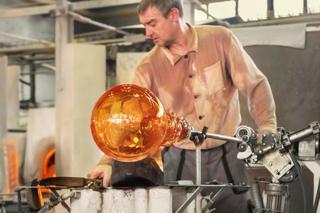 Transforming a hot mass of glass drawn from a hot oven into a work of art. The glass making process up close. Moser Glass Factory in Czech Republicのeditorial素材