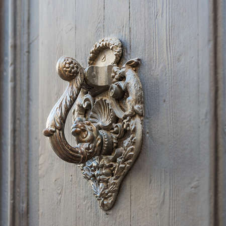 Antique handle on the museum door in Sitges, a city in Spain at the Mediterranean Sea