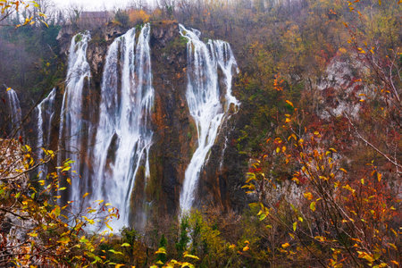 Great Waterfall in Plitvice National Park in Croatia on an autumn day, yellow foliage and turquoise water. Travel photoの写真素材