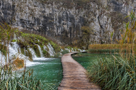 Autumn landscape. Waterfalls, rivers and lakes in cascades in Croatia. Plitvice Lakes National Park in azure to green, gray or blue. Paths between the lakesの写真素材