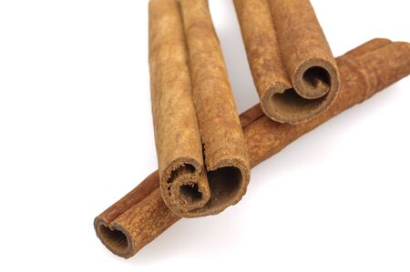 Cinnamon sticks on a white background. Fragrant spice close up view. Still life, isolated.