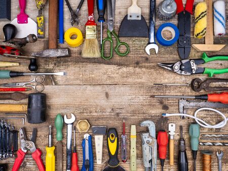 Construction tool on a wooden background.
