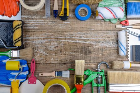 House painter tool on wooden background.