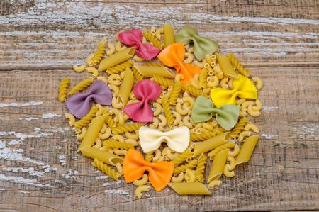 Assortment of pasta on the wooden background.の写真素材