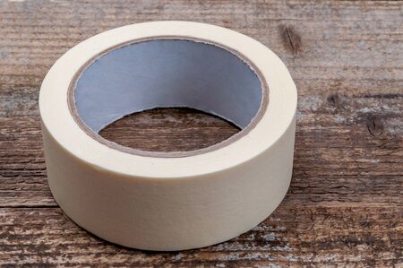Masking tape on wooden background. Repair tool, closeup view.の写真素材
