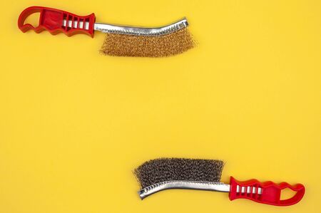 Brushes for cleaning metal on a yellow background. Paint tool closeup view.