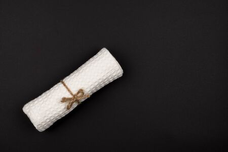 Tied with rope and a towel roll on a black background. The view from the top.の写真素材
