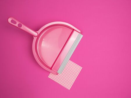 Scoop and a napkin on a pink background. The view from the top. Equipment for garbage collection.の写真素材