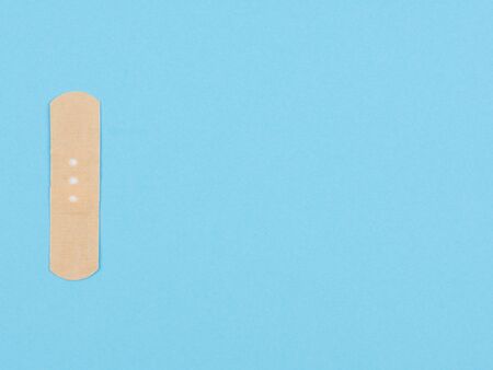 Aid plaster on a blue background. The view from the top.の写真素材
