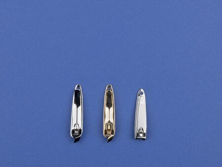 Accessories for manicure and pedicure on a blue background. The view from the top.