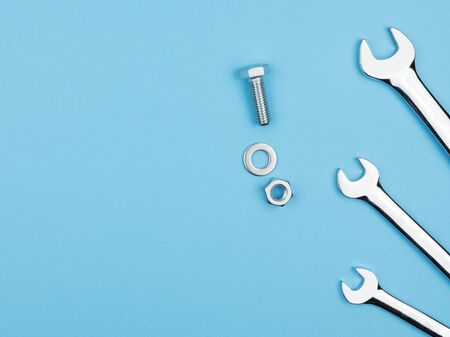 Manual keys, bolts and nuts on a blue background. Fixer. The view from the top.の写真素材