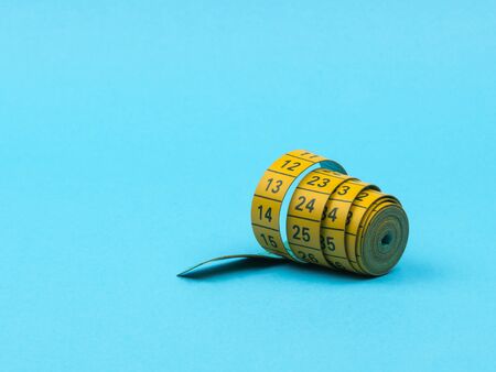 Tape the centimeter on a blue background. Roll. Tailoring