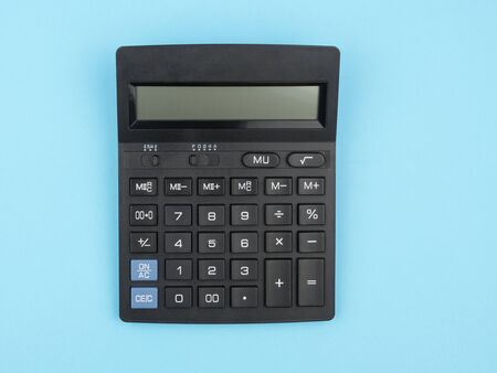 Calculator on a blue background closeup. The concept of calculation.の写真素材
